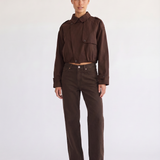 Woman wearing the Darcy brown cropped trench coat, front view