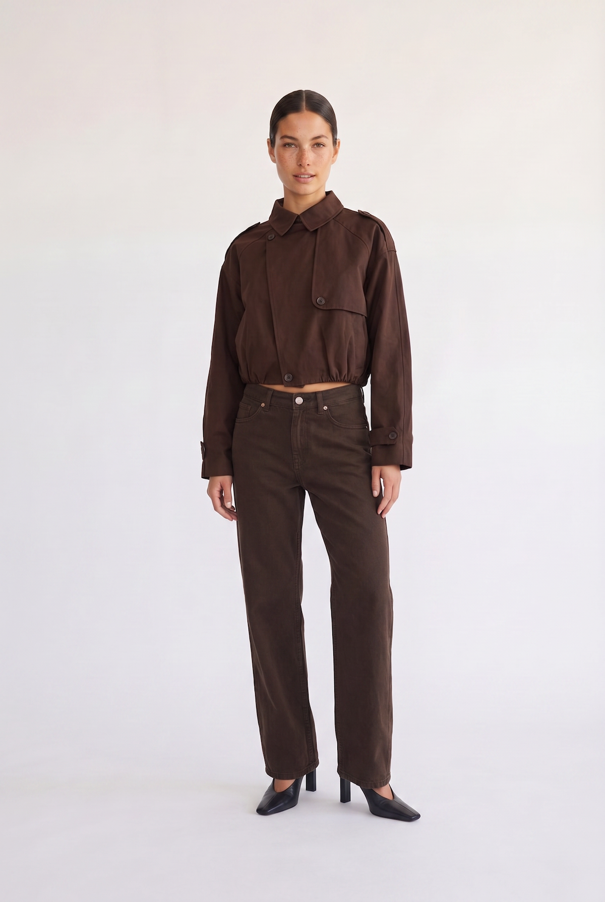Woman wearing the Darcy brown cropped trench coat, front view