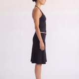 Model styling the Madison Skirt black scallop waist skirt