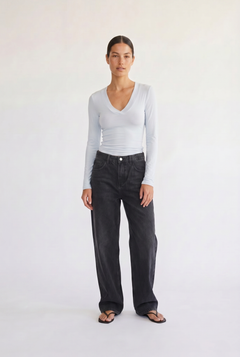 Woman wearing the Margaux baby blue deep v henley top, front view