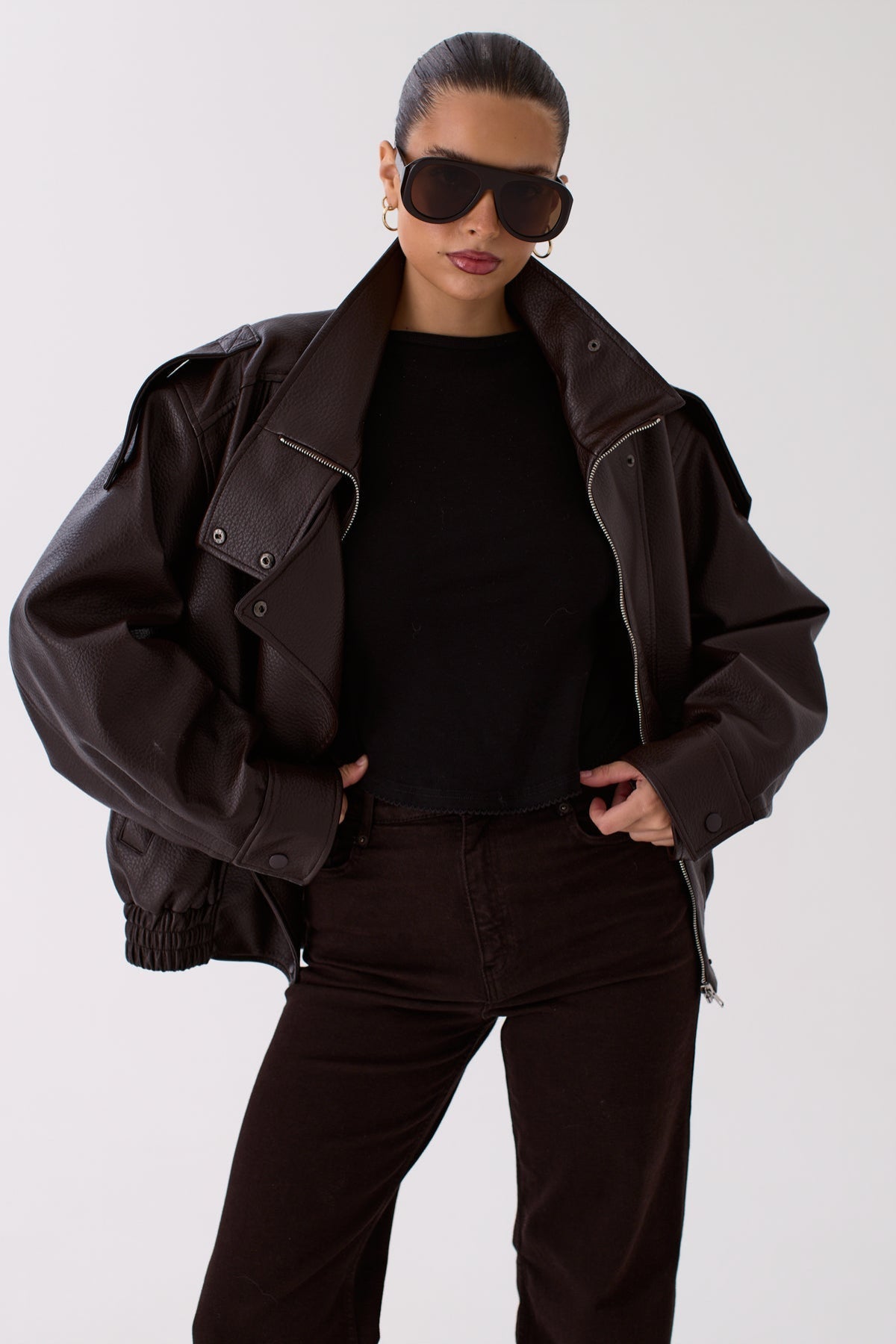 Model wearing the Zoe brown faux leather jacket, full-length