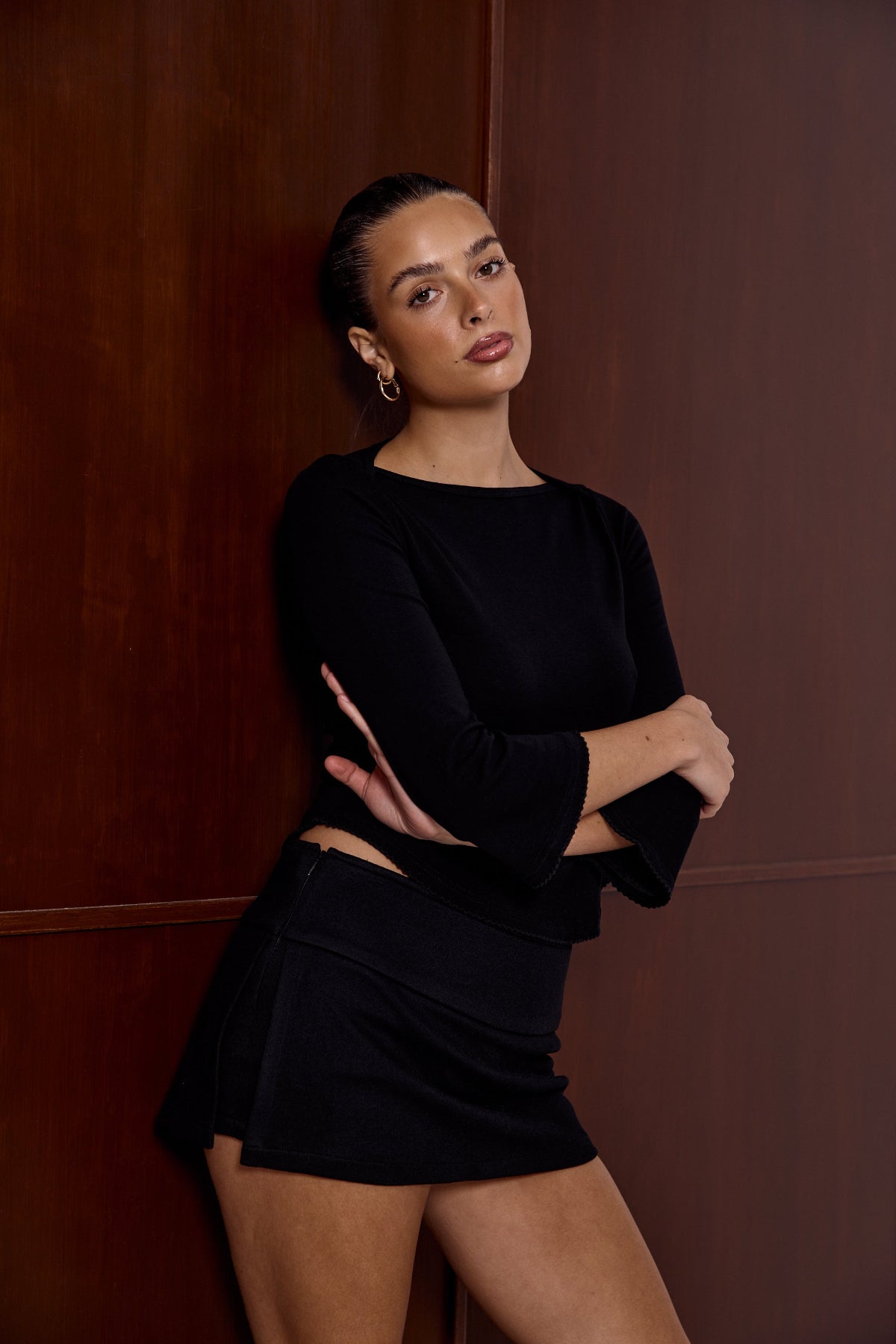 Model wearing the Lola black mini skirt, full-length