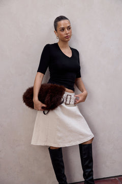Woman wearing the Ryan ivory pleated midi skirt, front view