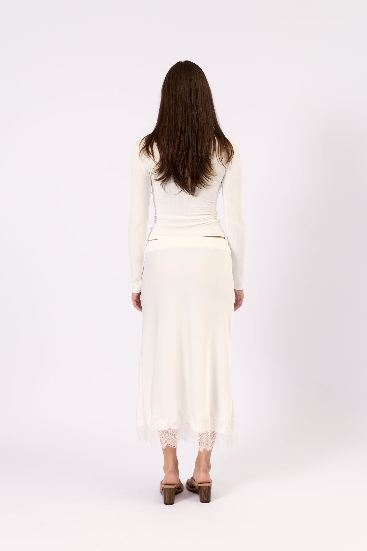 Model wearing the Noa Lace white lace top, close-up view
